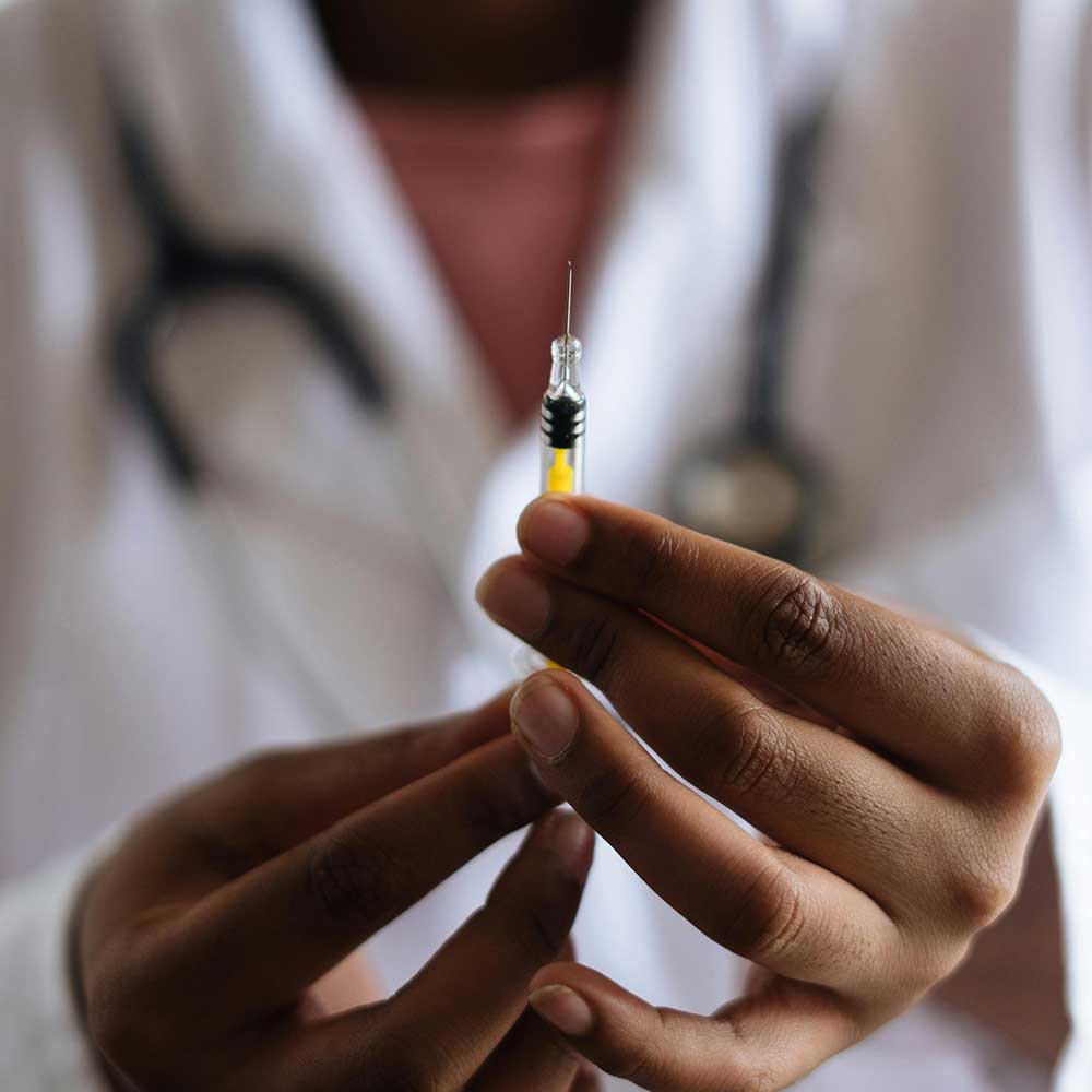Doctor holding syringe