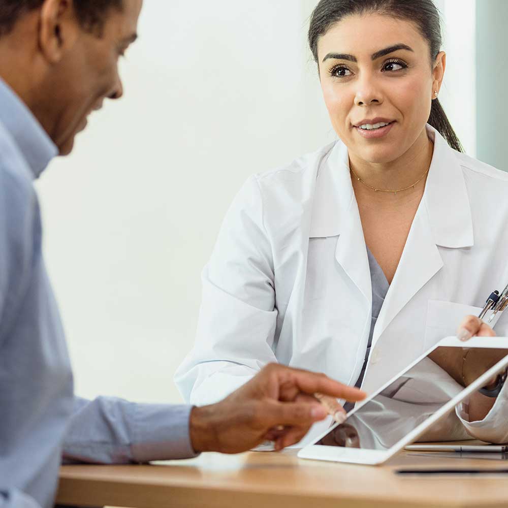 Doctor showing a patient information on an iPad